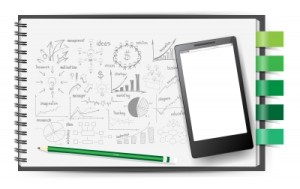 Mobile Phone On Notebook Paper Drawing Plan Concept by KROMKRATHOG / FreeDigitalPhotos