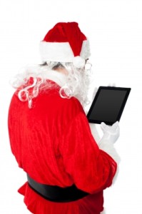 Santa Busy In Operating Tablet Pc by stockimages / FreeDigitalPhotos.net
